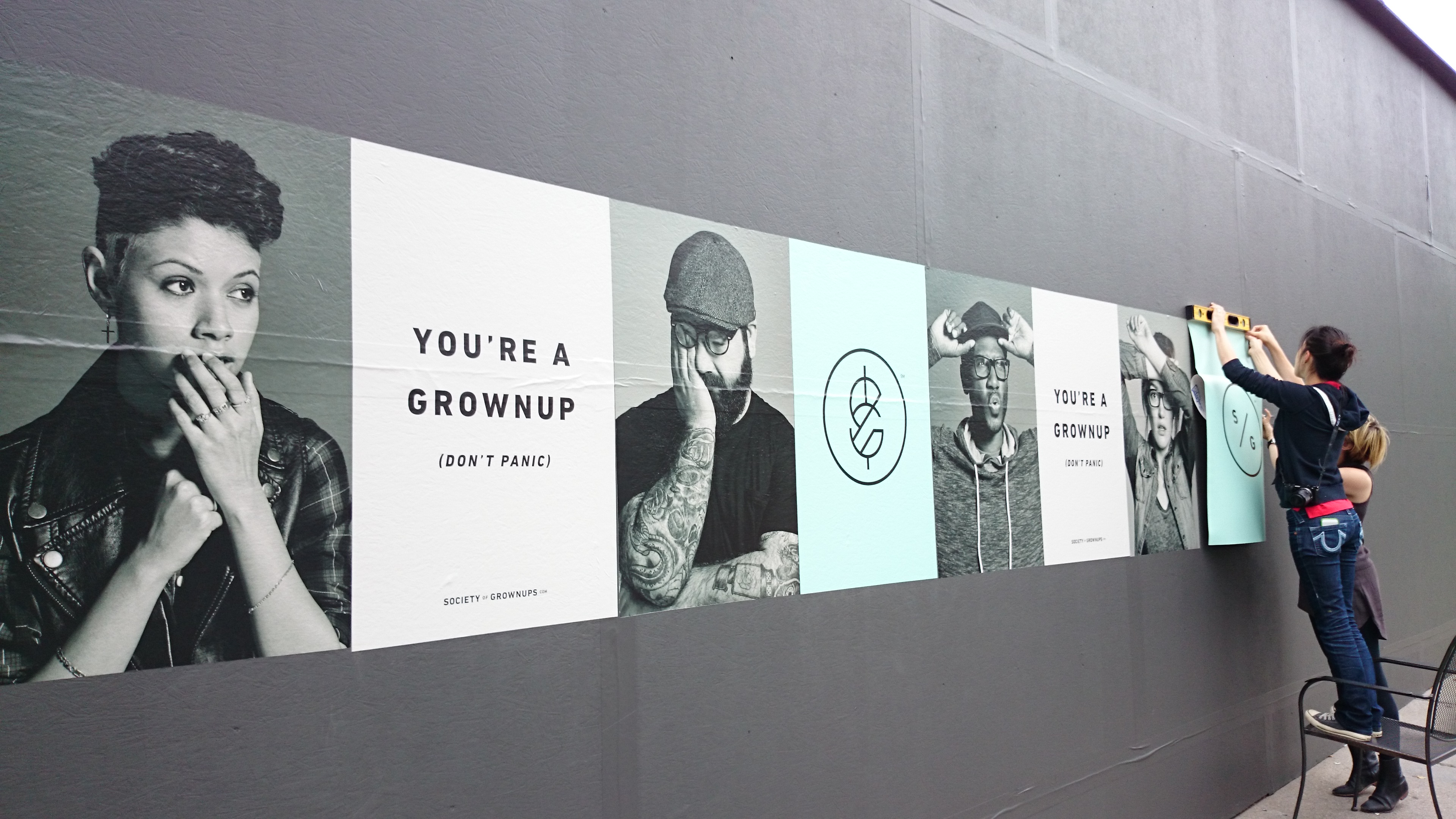Hanging advertisements on a wall